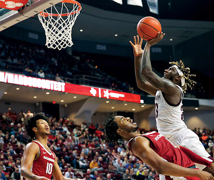 Arkansas Razorbacks guard Stanley Umude (0) is called for a foul against Texas A&M Aggies guard Tyrece Radford (23) the second half at Reed Arena. Texas A&M won, 86-81.